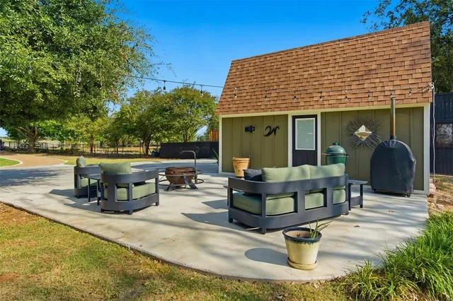 a front view of a house with sitting area and garden