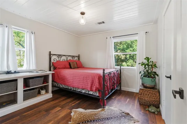 a bedroom with a bed and a potted plant