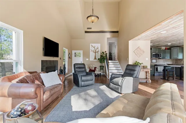 a living room with furniture fireplace and a flat screen tv