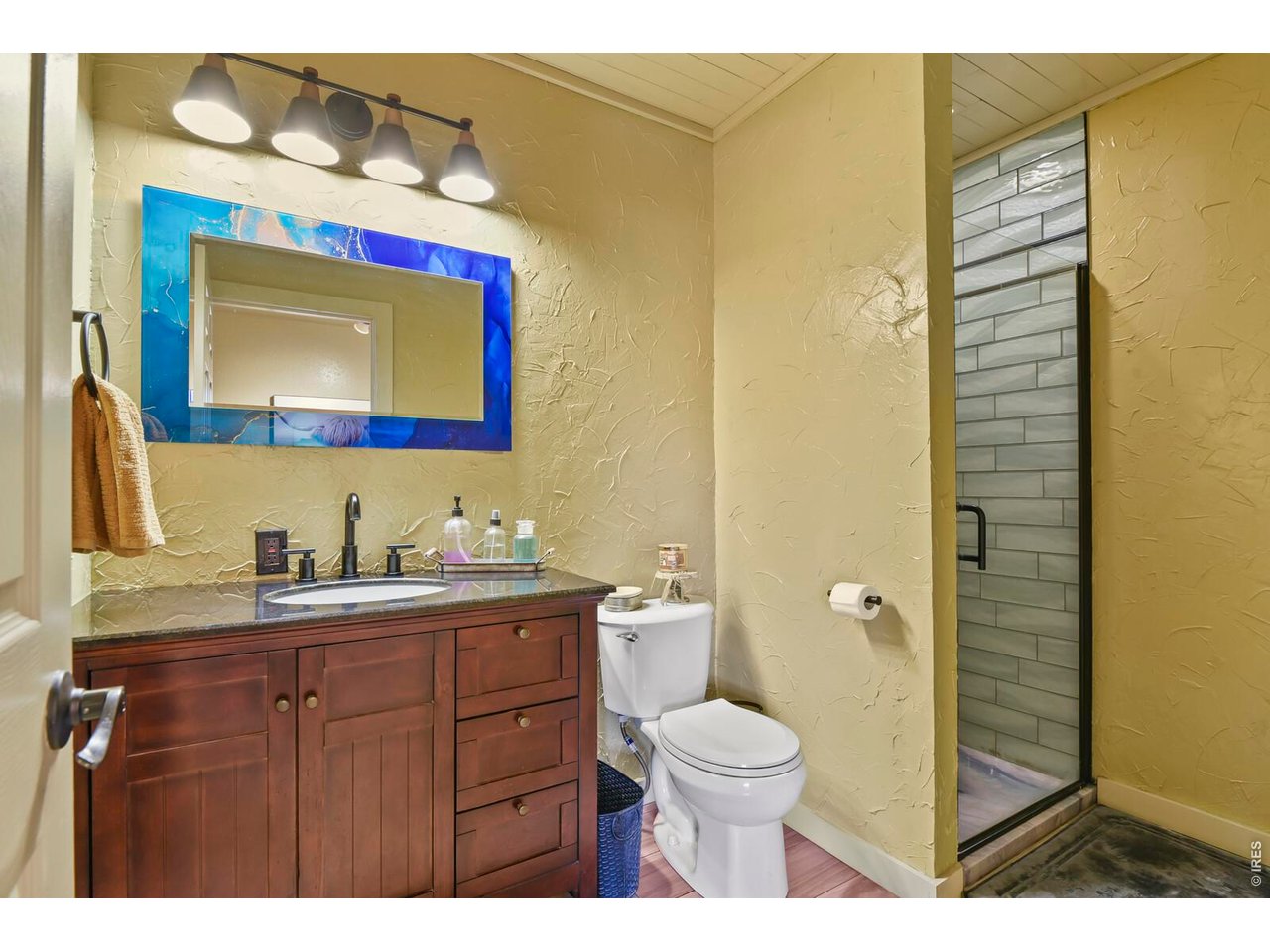 417 2nd Street Fort Lupton, CO 80621 - Photo 13 of 24 a bathroom with a toilet a sink and mirror
