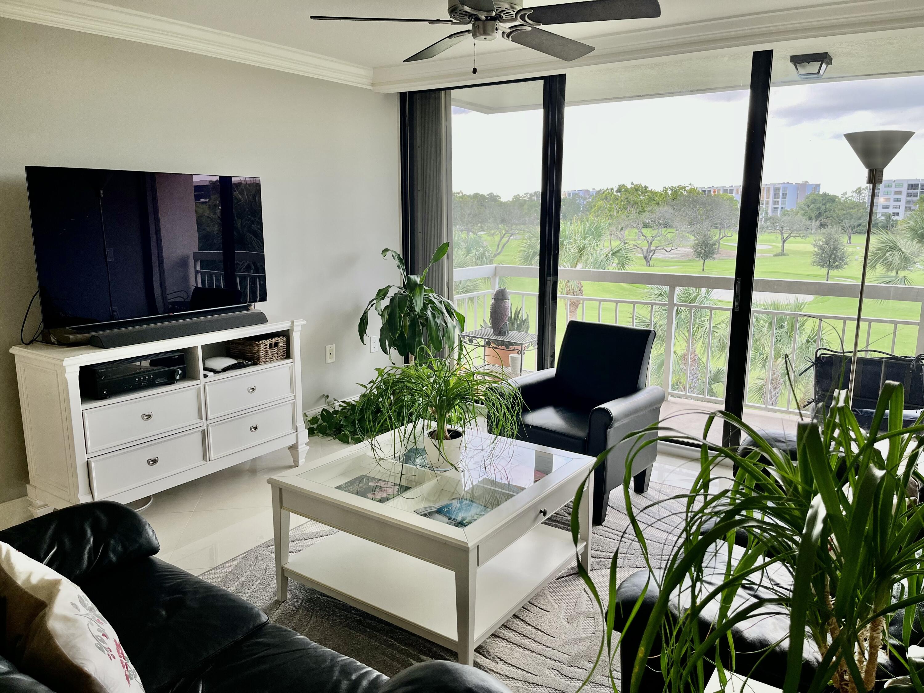 6169 Balboa Circle, Unit 401 Boca Raton, FL 33433 - Photo 15 of 34 a living room with furniture and a potted plant