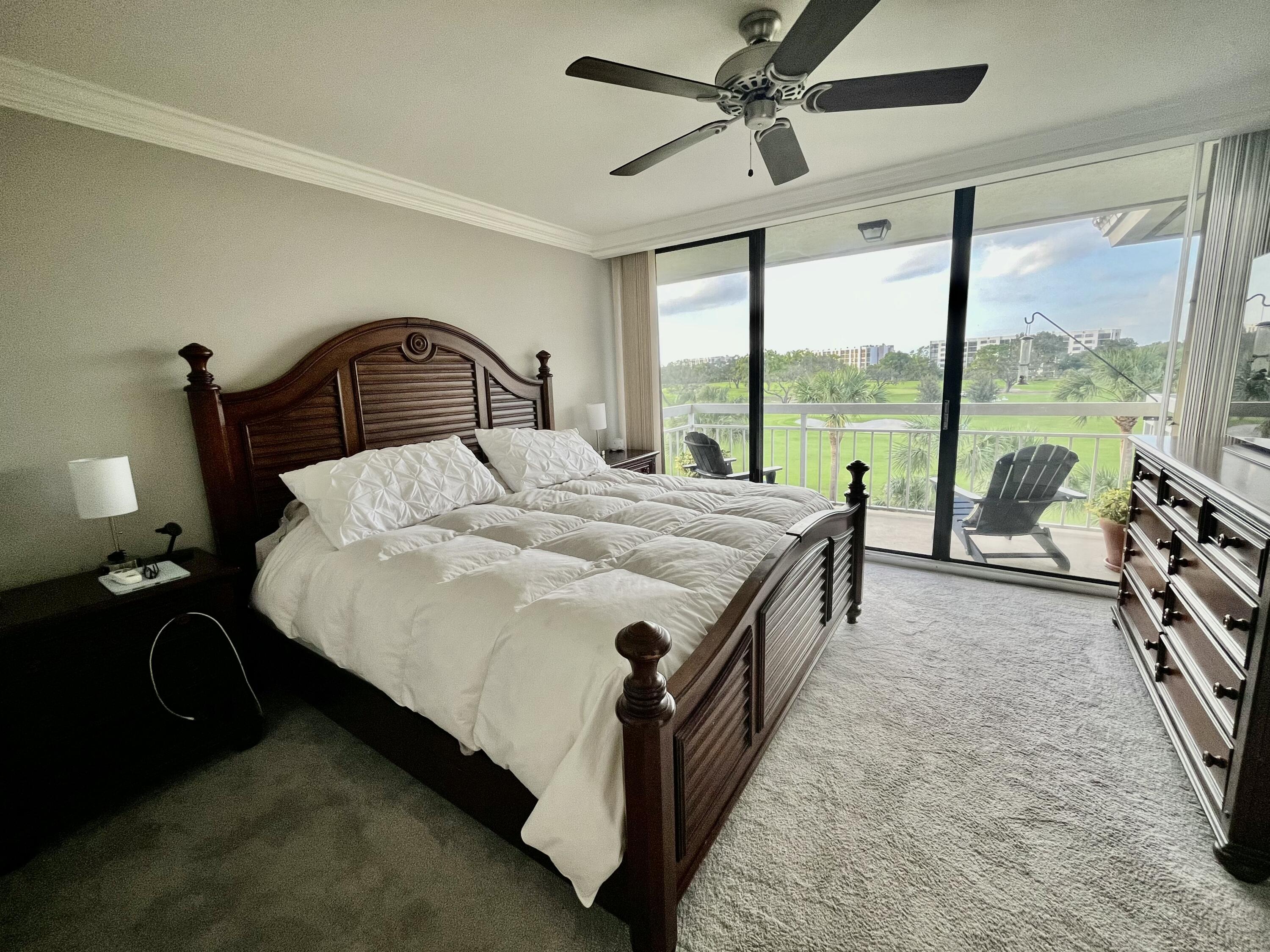6169 Balboa Circle, Unit 401 Boca Raton, FL 33433 - Photo 16 of 34 a bed room with a bed and a large window