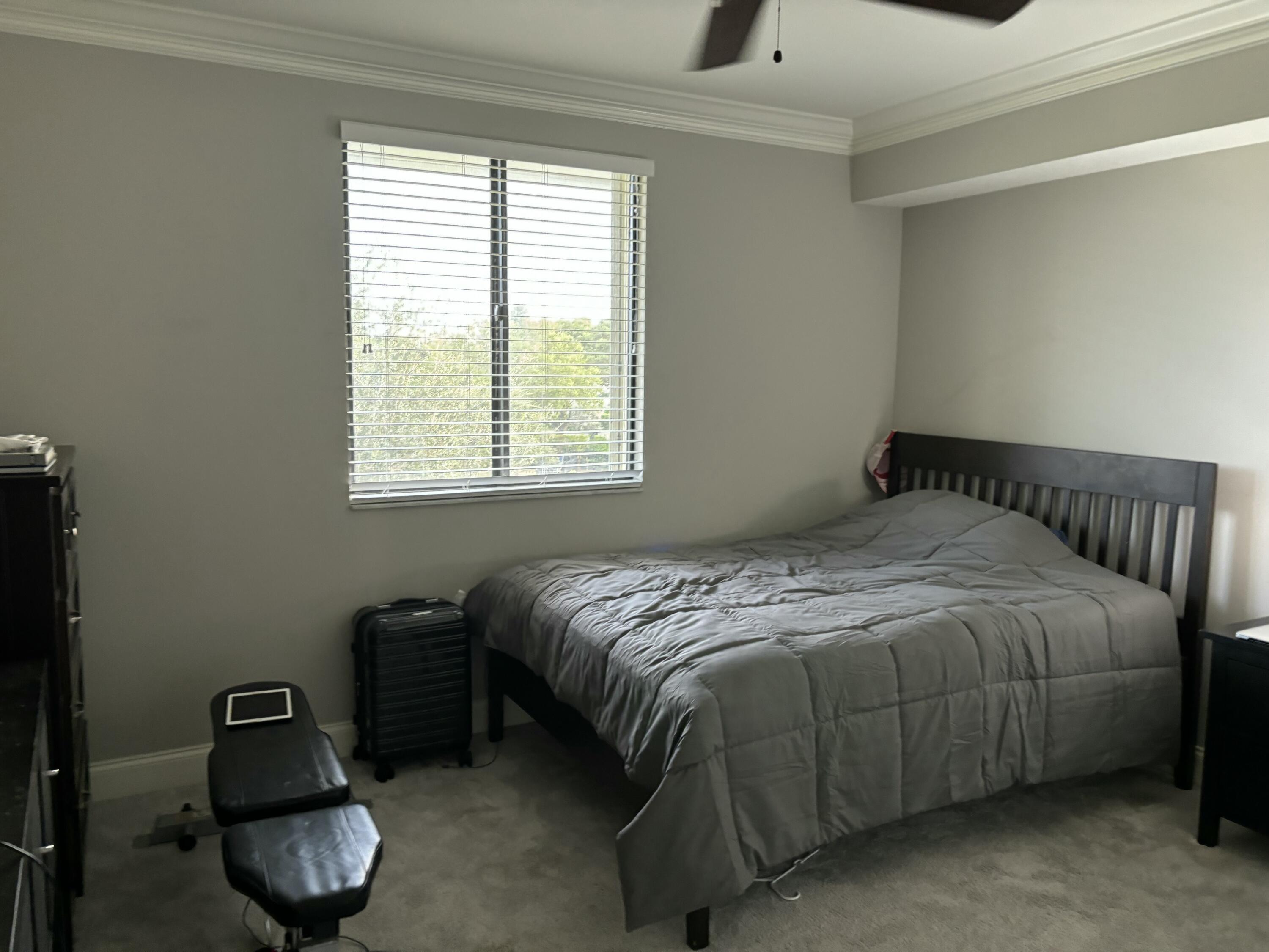 6169 Balboa Circle, Unit 401 Boca Raton, FL 33433 - Photo 25 of 34 a bedroom with a bed and a window