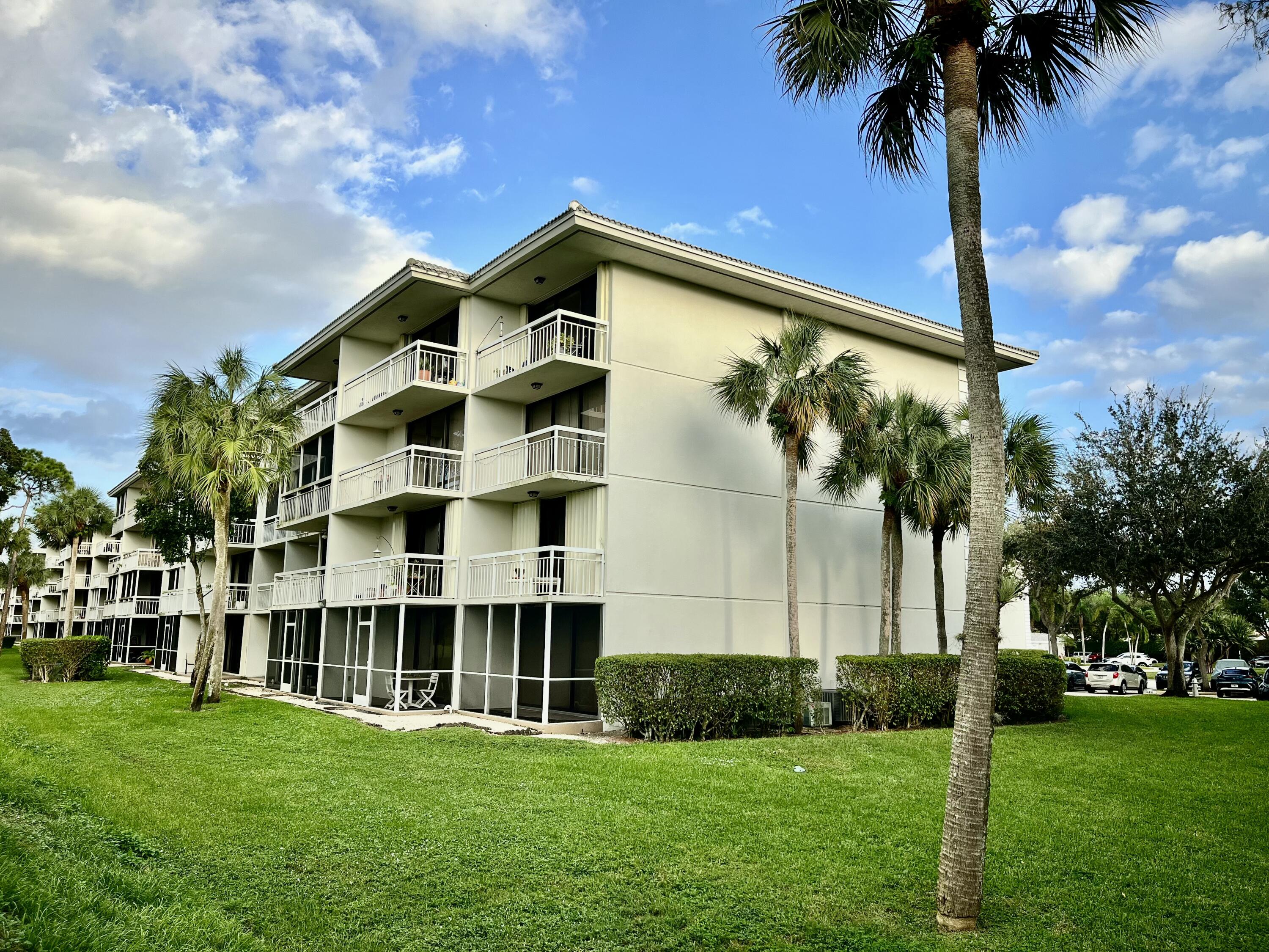 6169 Balboa Circle, Unit 401 Boca Raton, FL 33433 - Photo 32 of 34 a front view of building with yard