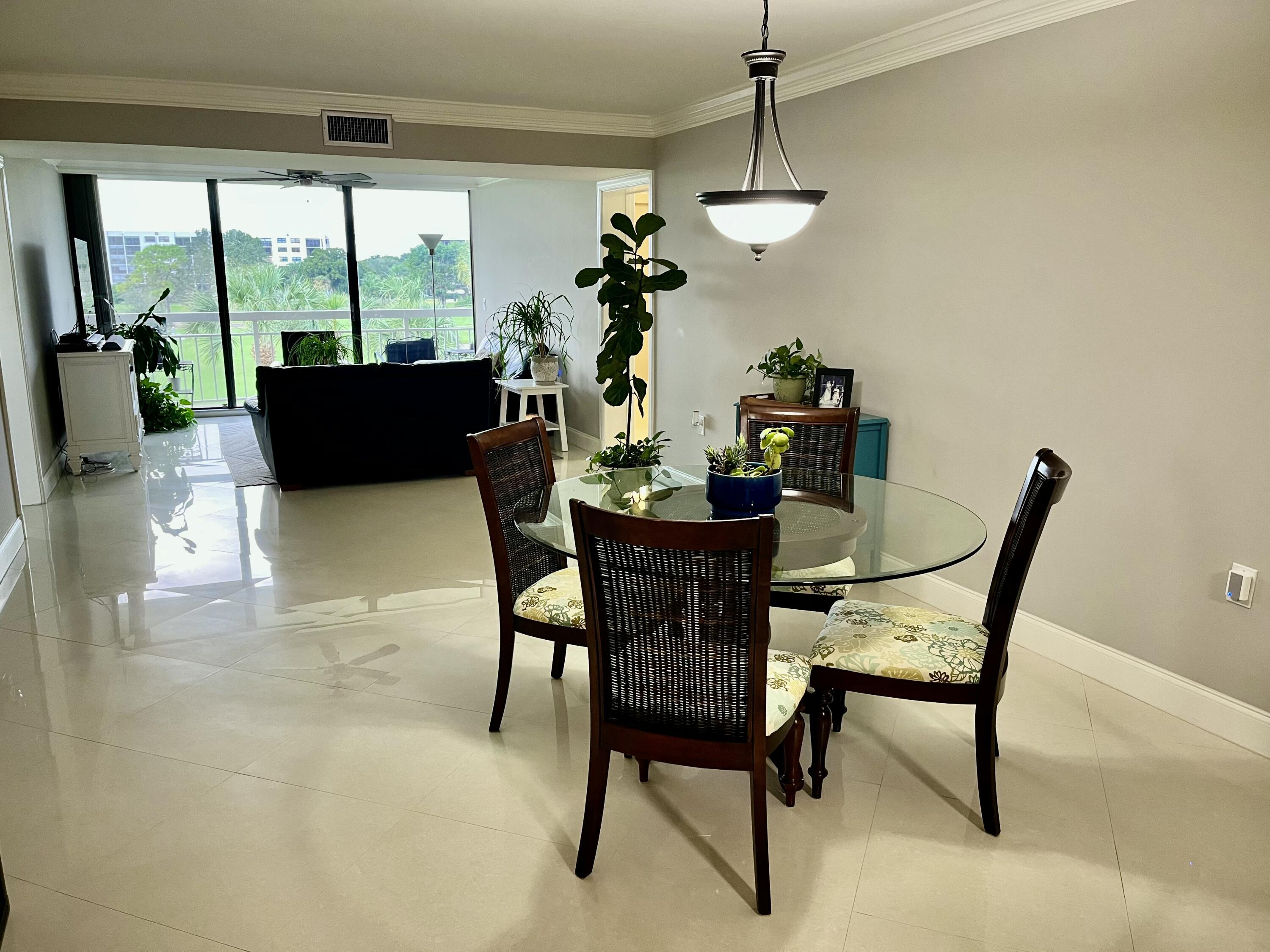 6169 Balboa Circle, Unit 401 Boca Raton, FL 33433 - Photo 6 of 34 a view of a dining room with furniture window and outside view