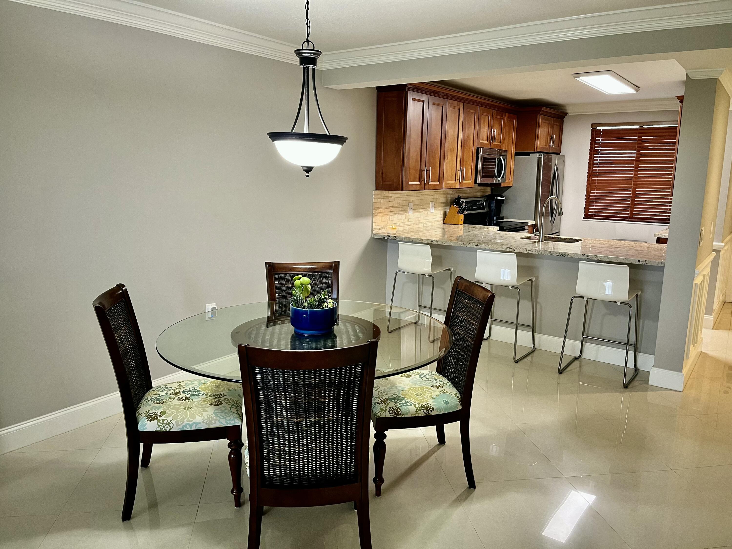 6169 Balboa Circle, Unit 401 Boca Raton, FL 33433 - Photo 7 of 34 a view of a dining room with furniture