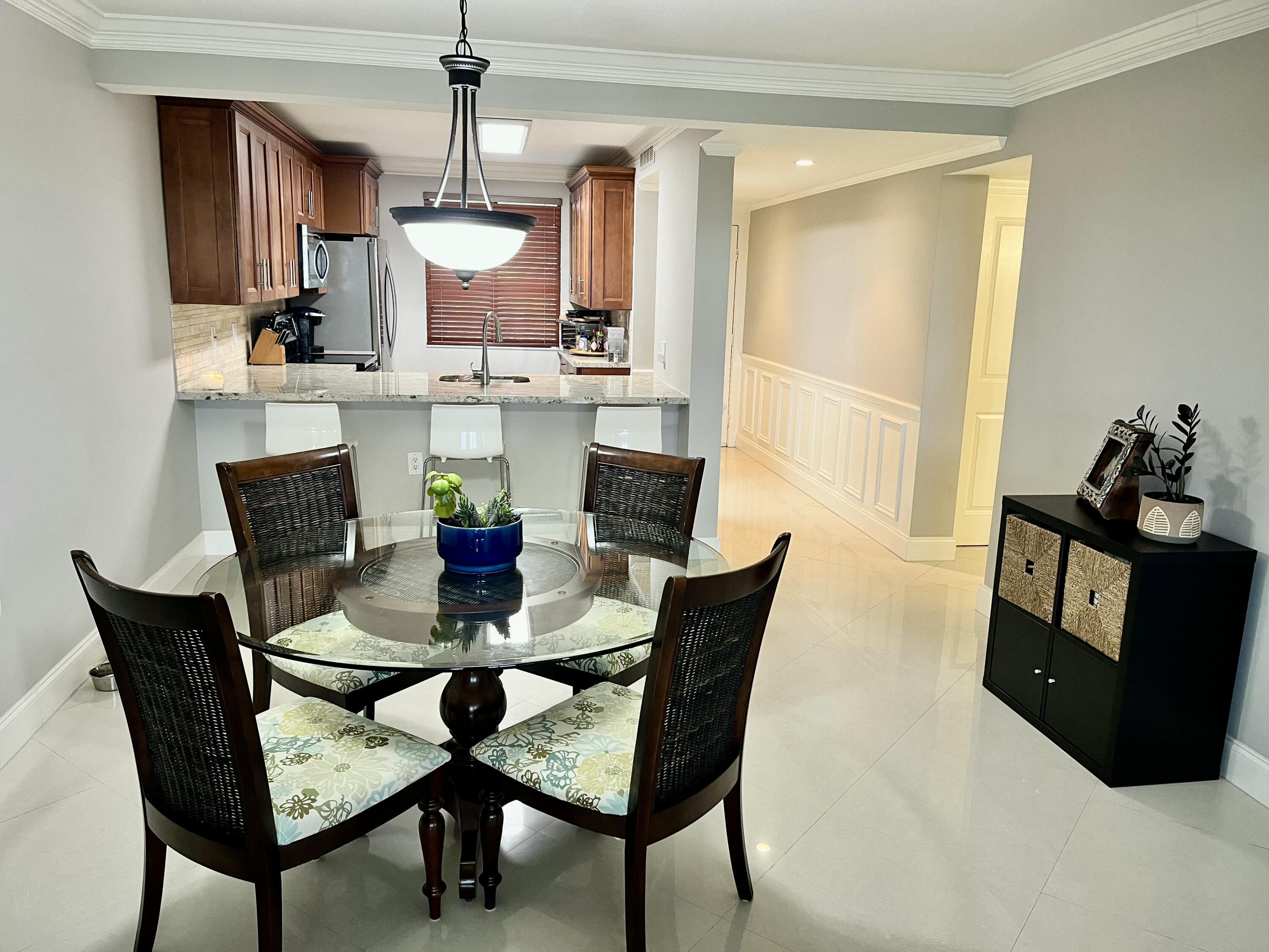6169 Balboa Circle, Unit 401 Boca Raton, FL 33433 - Photo 8 of 34 a view of a dining room with furniture
