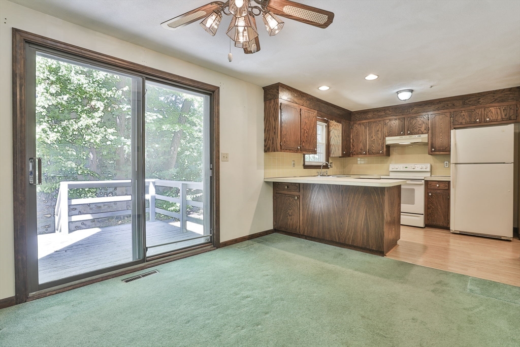 101 Drummer Road, Unit 101 Acton, MA 01720 - Photo 11 of 31 a kitchen with kitchen island a large counter top space appliances and cabinets