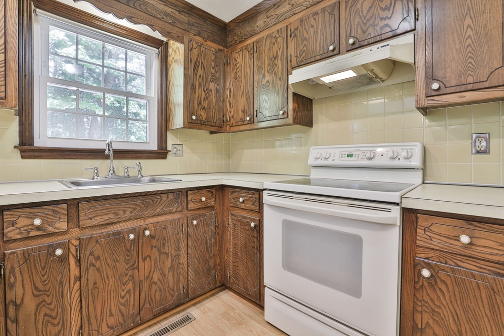 101 Drummer Road, Unit 101 Acton, MA 01720 - Photo 13 of 31 a kitchen with stainless steel appliances granite countertop a sink stove and cabinets