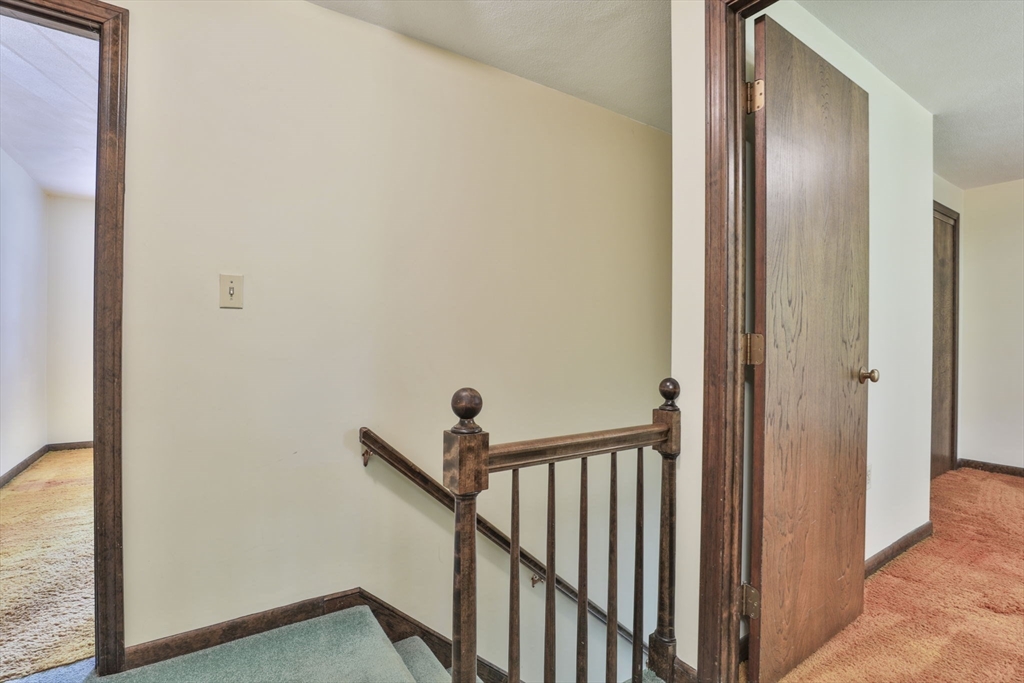 101 Drummer Road, Unit 101 Acton, MA 01720 - Photo 16 of 31 a view of a hallway with wooden floor and a bathroom