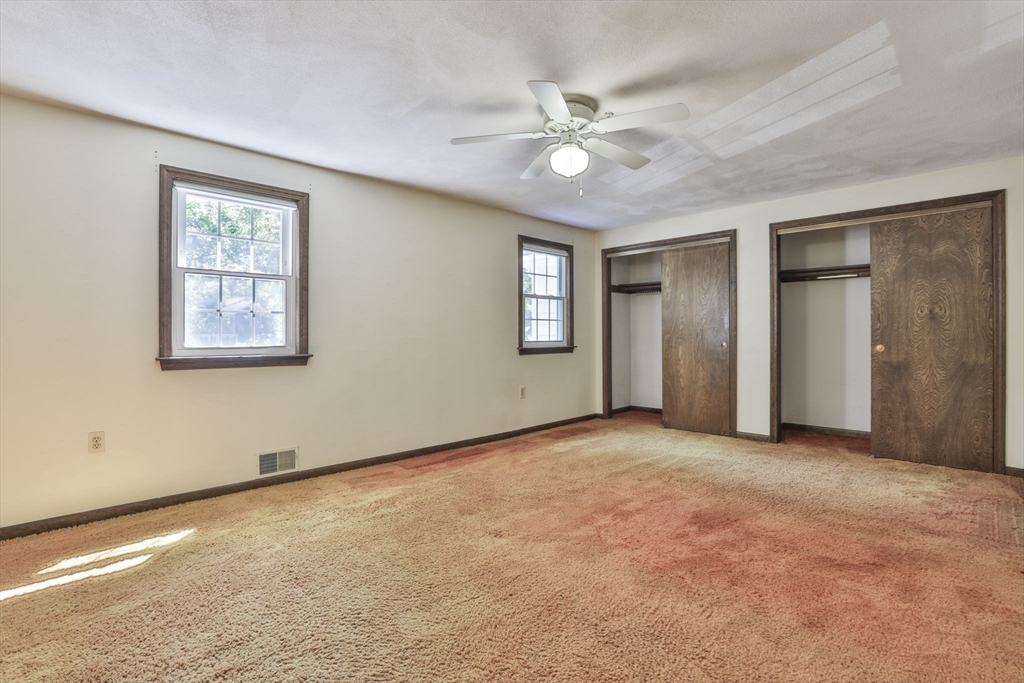 101 Drummer Road, Unit 101 Acton, MA 01720 - Photo 17 of 31 an empty room with fan and windows