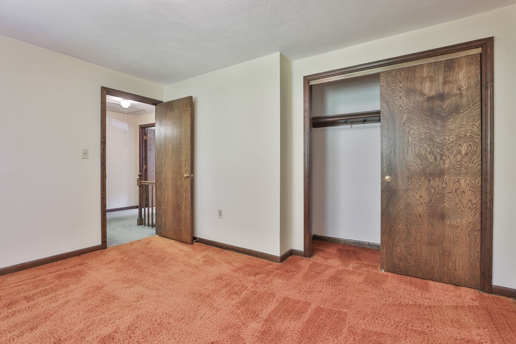 101 Drummer Road, Unit 101 Acton, MA 01720 - Photo 21 of 31 a view of an empty room with closet and a bathroom