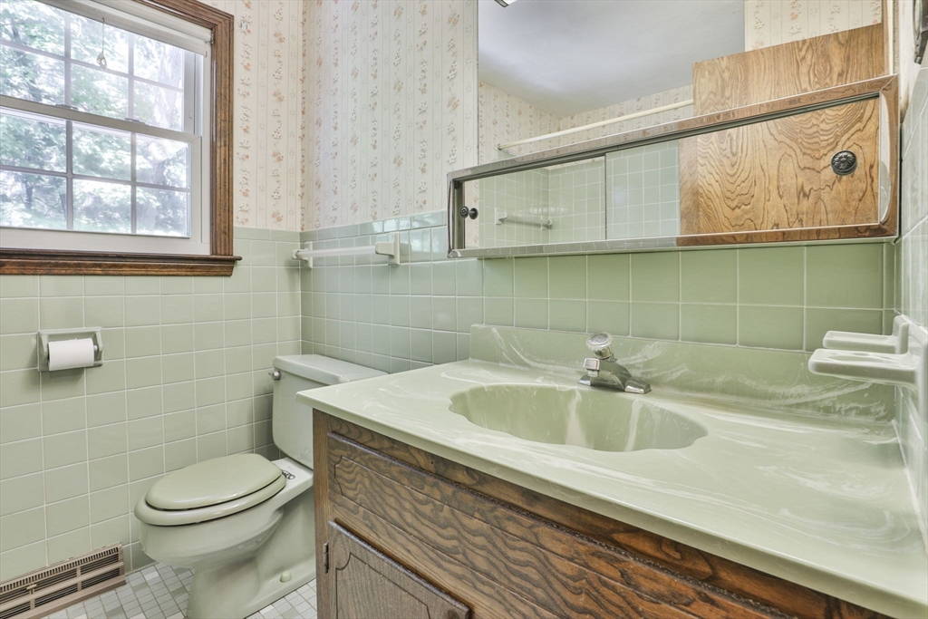101 Drummer Road, Unit 101 Acton, MA 01720 - Photo 23 of 31 a bathroom with a sink a toilet and a mirror