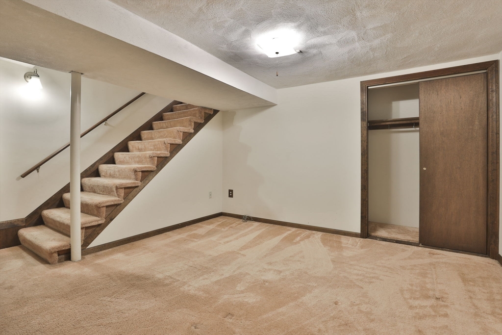 101 Drummer Road, Unit 101 Acton, MA 01720 - Photo 26 of 31 a view of an empty room with stairs