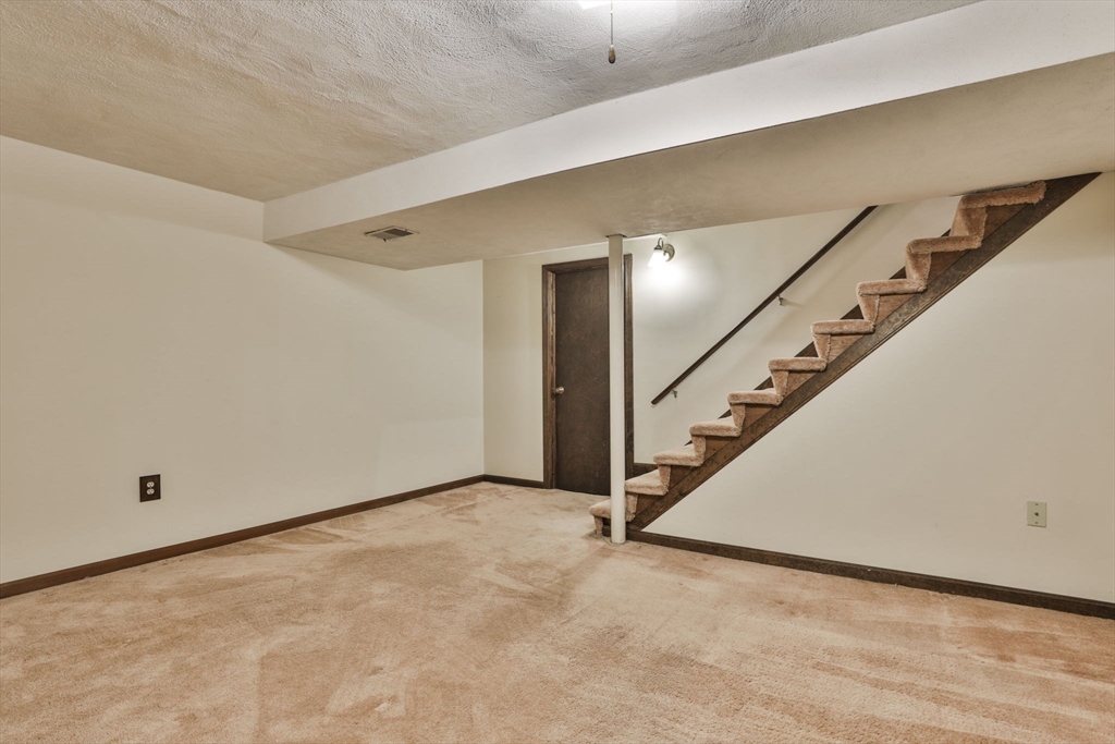 101 Drummer Road, Unit 101 Acton, MA 01720 - Photo 27 of 31 a view of an empty room with stairs