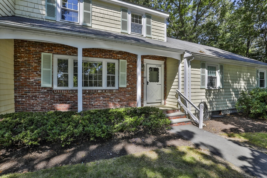 101 Drummer Road, Unit 101 Acton, MA 01720 - Photo 3 of 31 a view of a house with brick walls and a yard