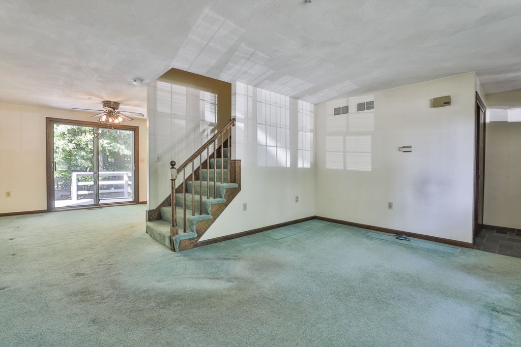 101 Drummer Road, Unit 101 Acton, MA 01720 - Photo 6 of 31 a view of an empty room with windows