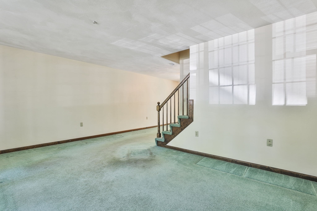 101 Drummer Road, Unit 101 Acton, MA 01720 - Photo 8 of 31 a view of an empty room with a window