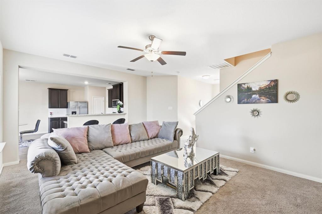 227 Curt Street Anna, TX 75409 - Photo 8 of 40 Living area featuring carpet floors and a ceiling fan