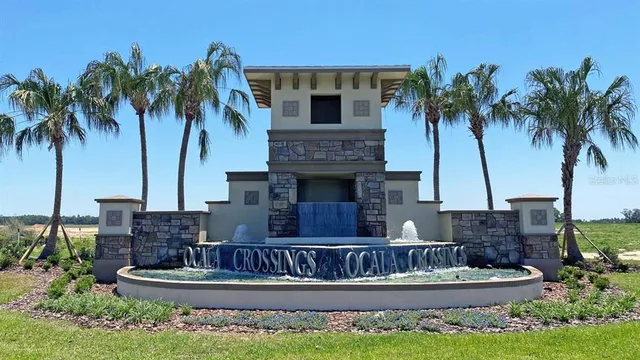 a view of a house with a yard and palm trees