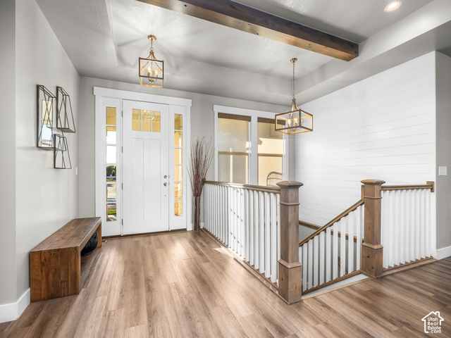 474 North 150th Street East Mapleton, UT 84664 - Photo 3 of 35 Entryway featuring wood-finish flooring, white shiplap accent wall, white spindle railing, and exposed ceiling beams