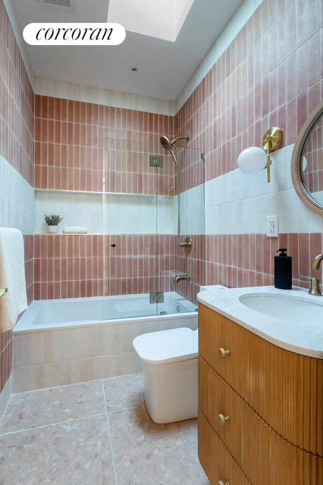 681 Decatur Street Brooklyn, NY 11233 - Photo 11 of 14 a bathroom with a bathtub and a sink