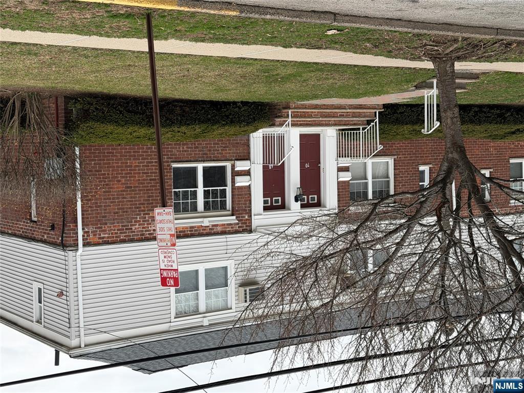 68 Hastings Avenue, Unit B Rutherford, NJ 07070 - Photo 3 of 3 a view of a house with a small yard and large tree