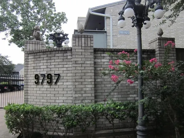 a view of building with wooden stairs and potted plants