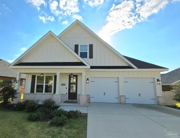 a view of a house with a yard and potted plants