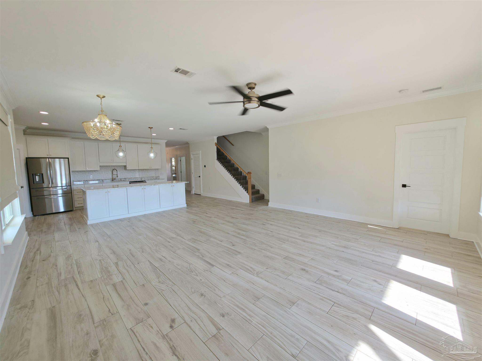 5642 Dunbar Circle Milton, FL 32583 - Photo 11 of 33 a view of a kitchen with a sink and wooden floor