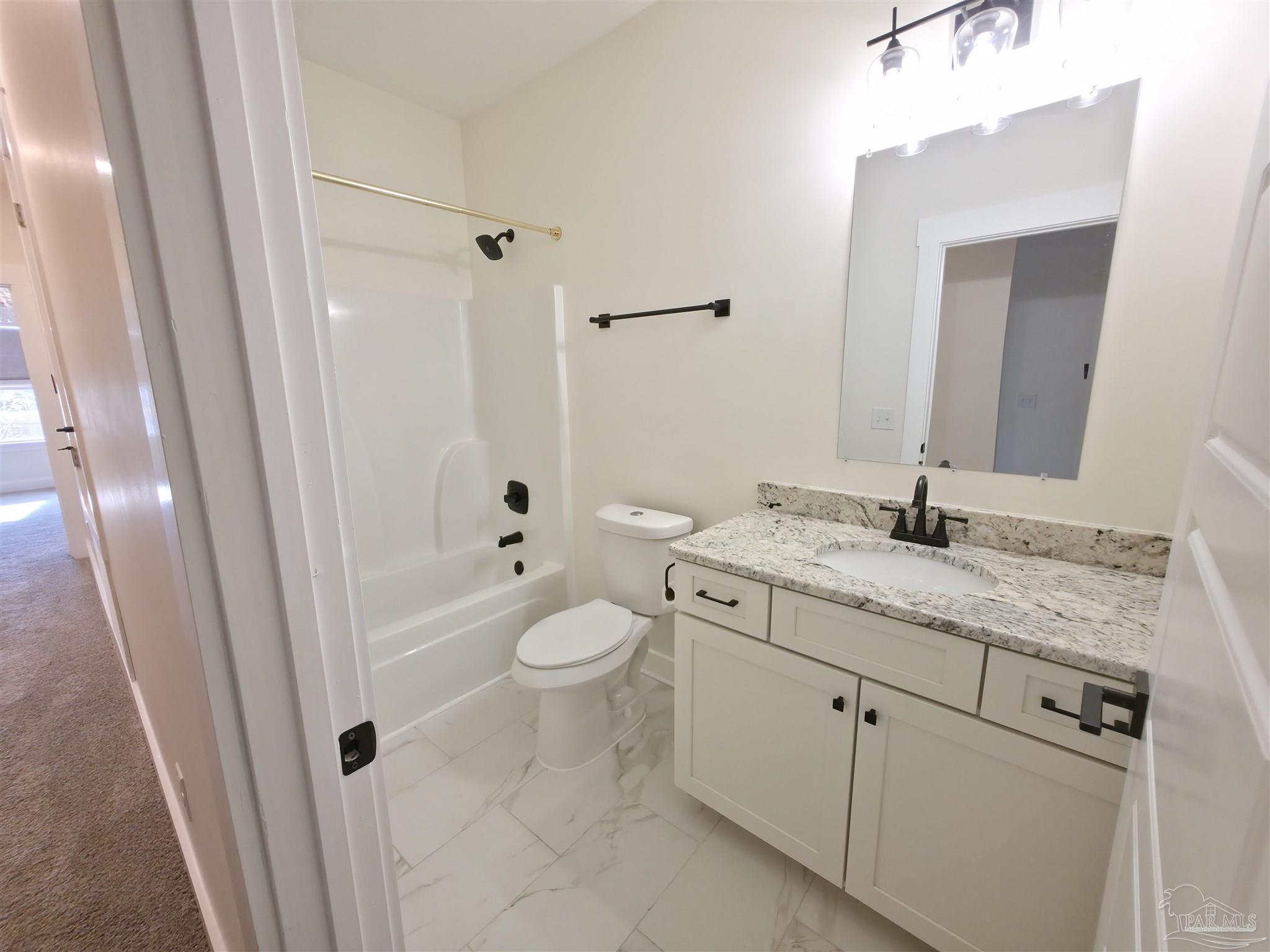 5642 Dunbar Circle Milton, FL 32583 - Photo 20 of 33 a bathroom with a granite countertop sink toilet and shower