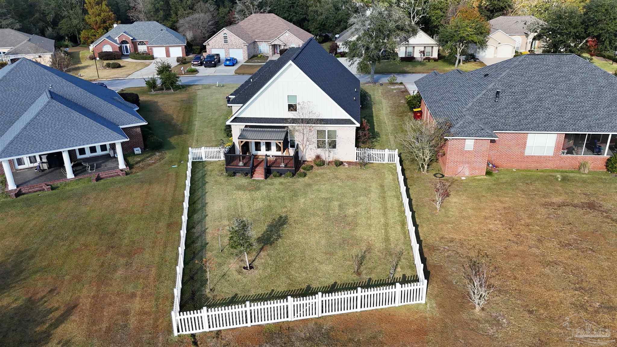 5642 Dunbar Circle Milton, FL 32583 - Photo 30 of 33 an aerial view of a house with swimming pool and large trees
