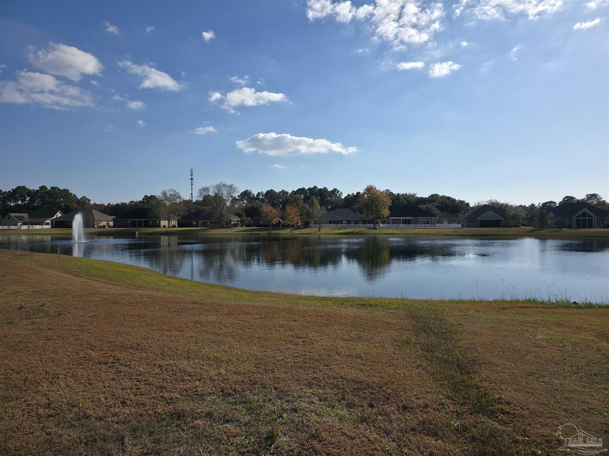 5642 Dunbar Circle Milton, FL 32583 - Photo 4 of 33 a view of a lake with houses in the back