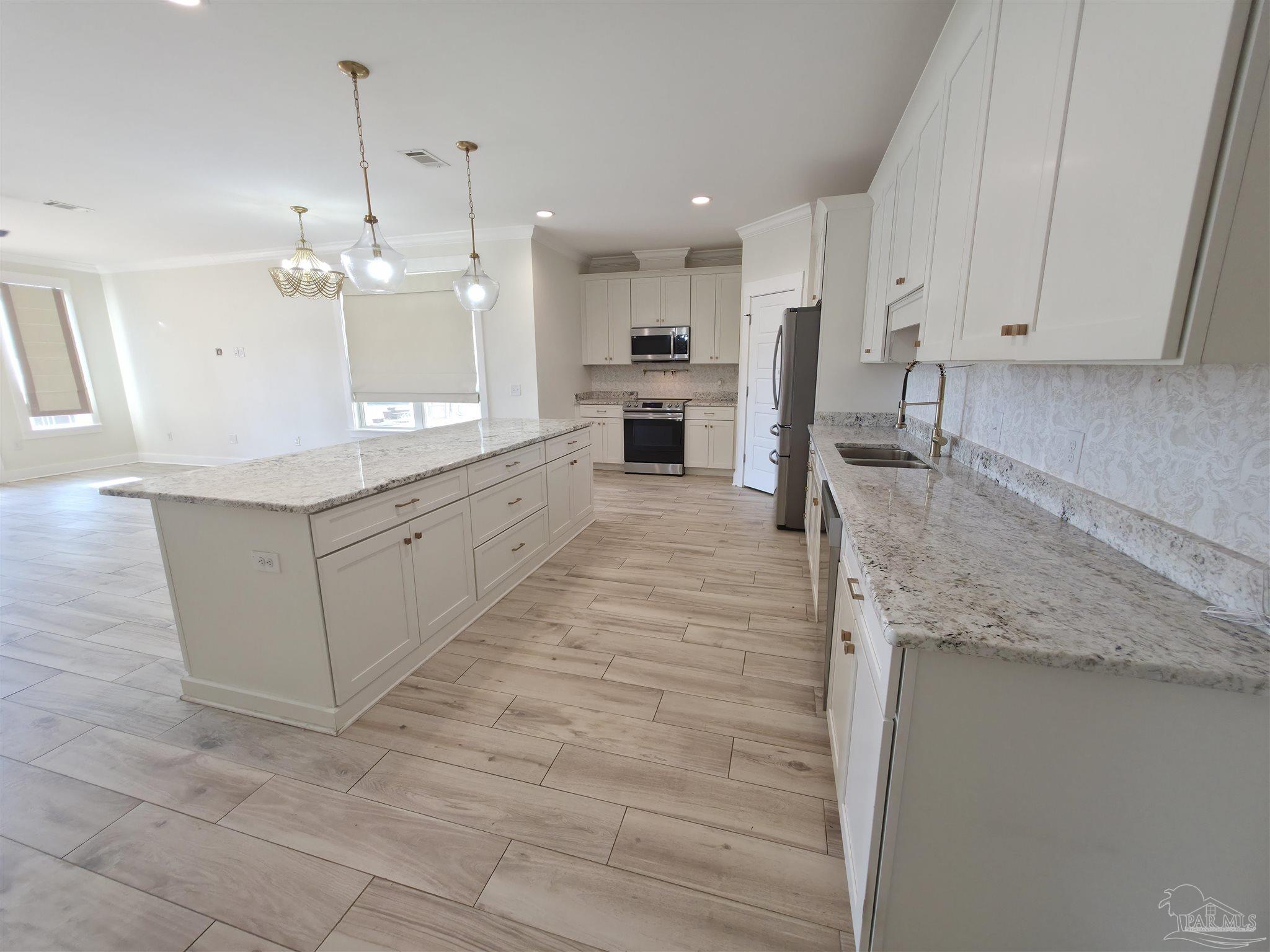 5642 Dunbar Circle Milton, FL 32583 - Photo 10 of 33 a large kitchen with cabinets