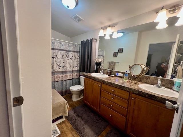 1650 Villa Avenue, Unit 9 Clovis, CA 93612 - Photo 23 of 29 a bathroom with a double vanity sink a toilet a shower and a mirror
