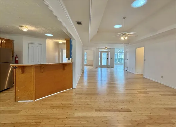 a view of a hallway with wooden floor