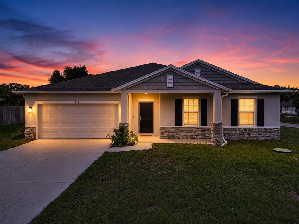 418 Fleming Street Sebastian, FL 32958 - Photo 1 of 38 a front view of a house with a garden and yard