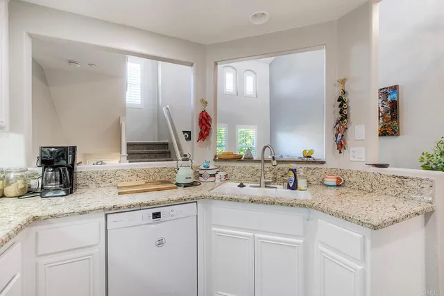 a bathroom with double sink and a mirror