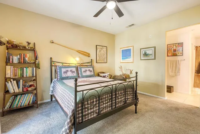 a bedroom with a bed window and book shelf
