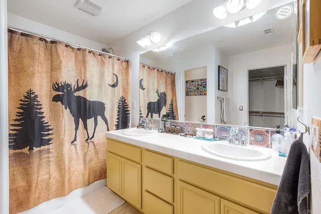 a bathroom with a double vanity sink and a mirror
