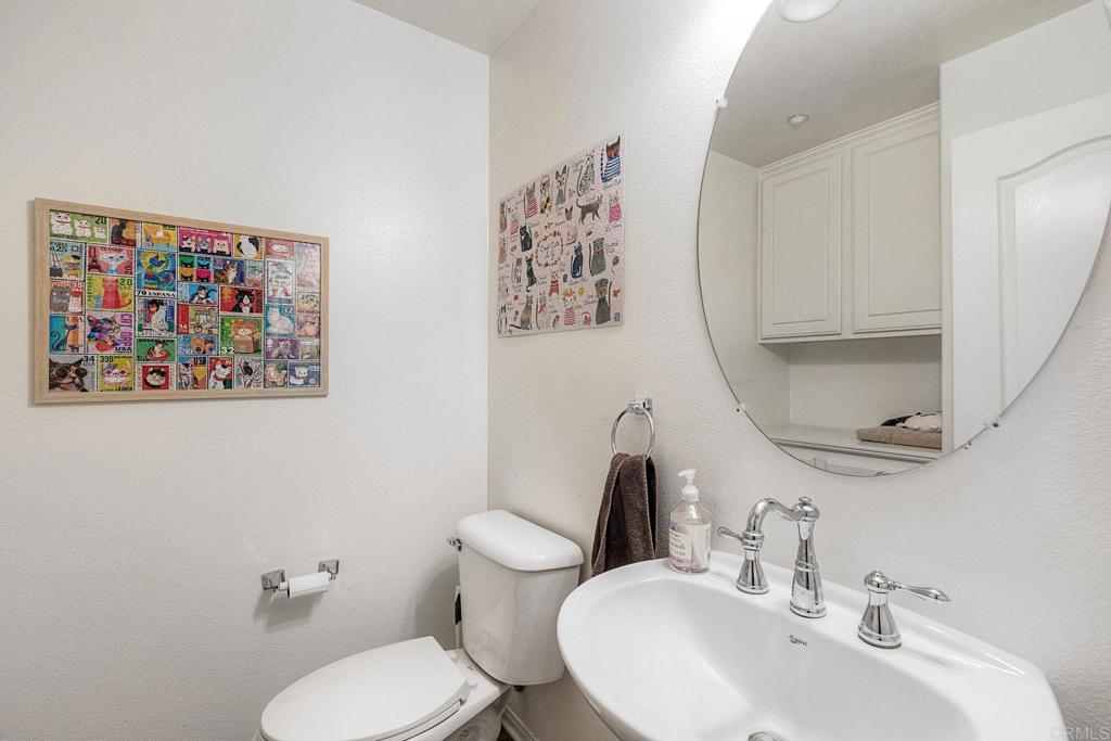 40238 Rosewell Court Temecula, CA 92591 - Photo 21 of 38 a bathroom with a toilet sink and mirror