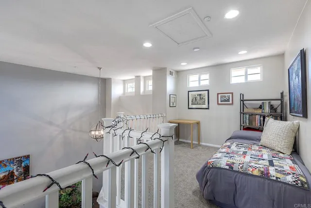 a spacious bedroom with furniture and a wooden floor