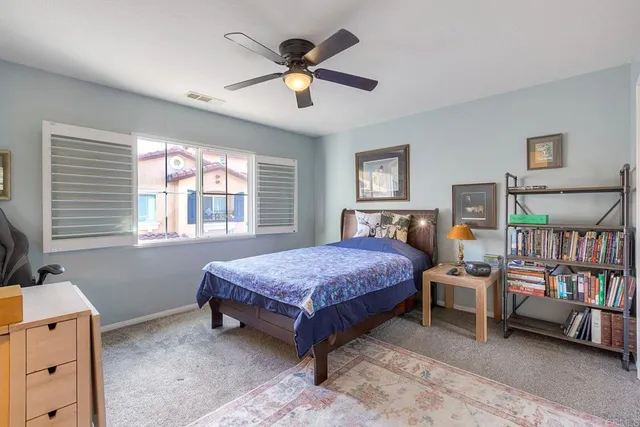 a bedroom with a bed a dresser and a book shelf