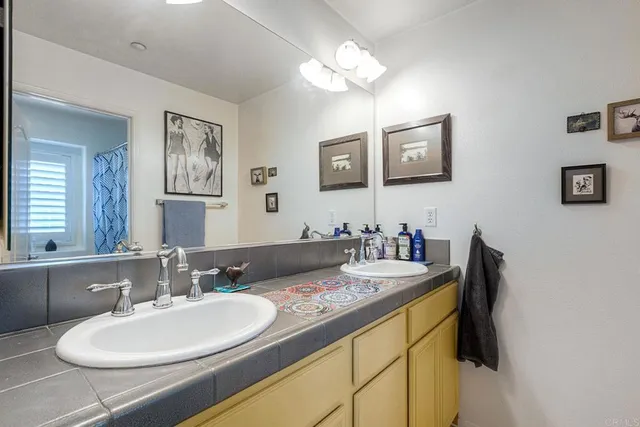 a bathroom with a double vanity sink and a mirror