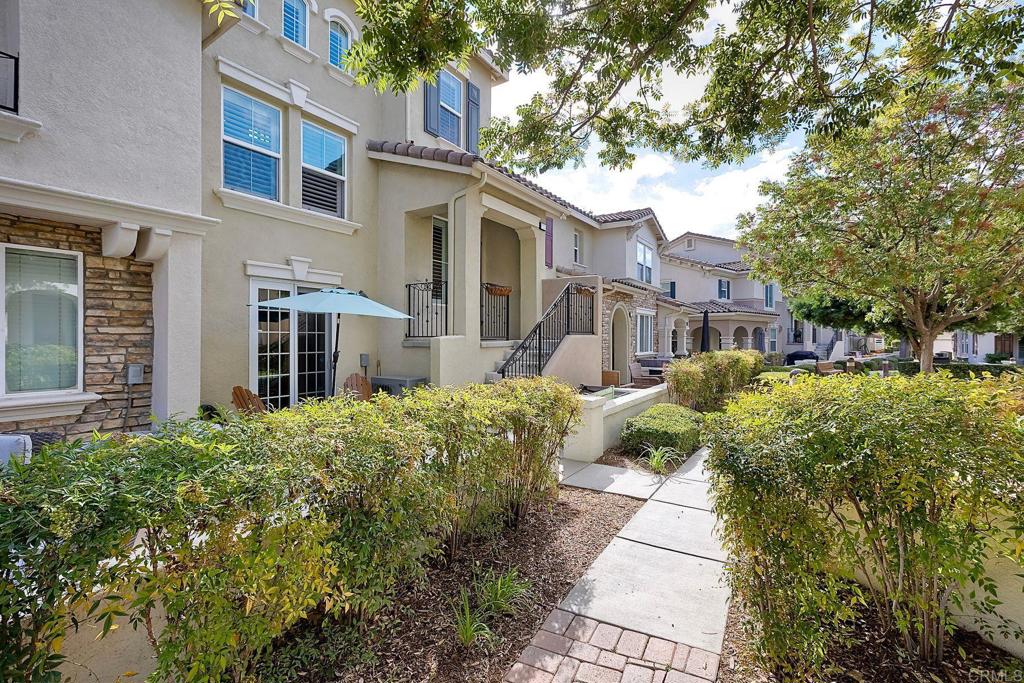 40238 Rosewell Court Temecula, CA 92591 - Photo 3 of 38 a front view of a house with a yard and potted plants