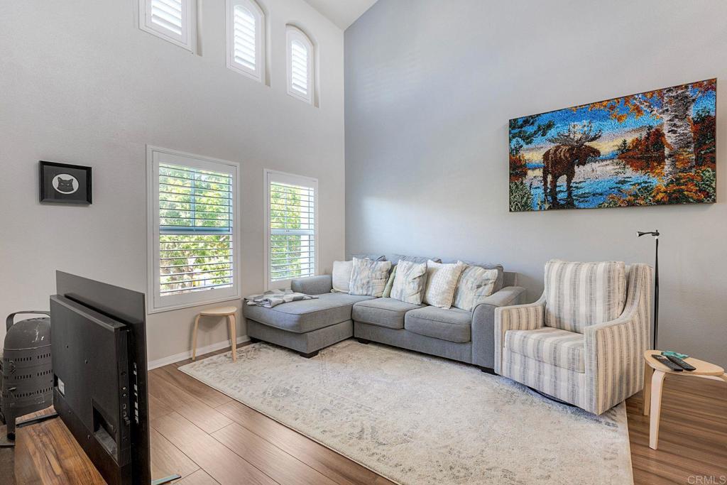 40238 Rosewell Court Temecula, CA 92591 - Photo 6 of 38 a living room with furniture a fireplace and a flat screen tv