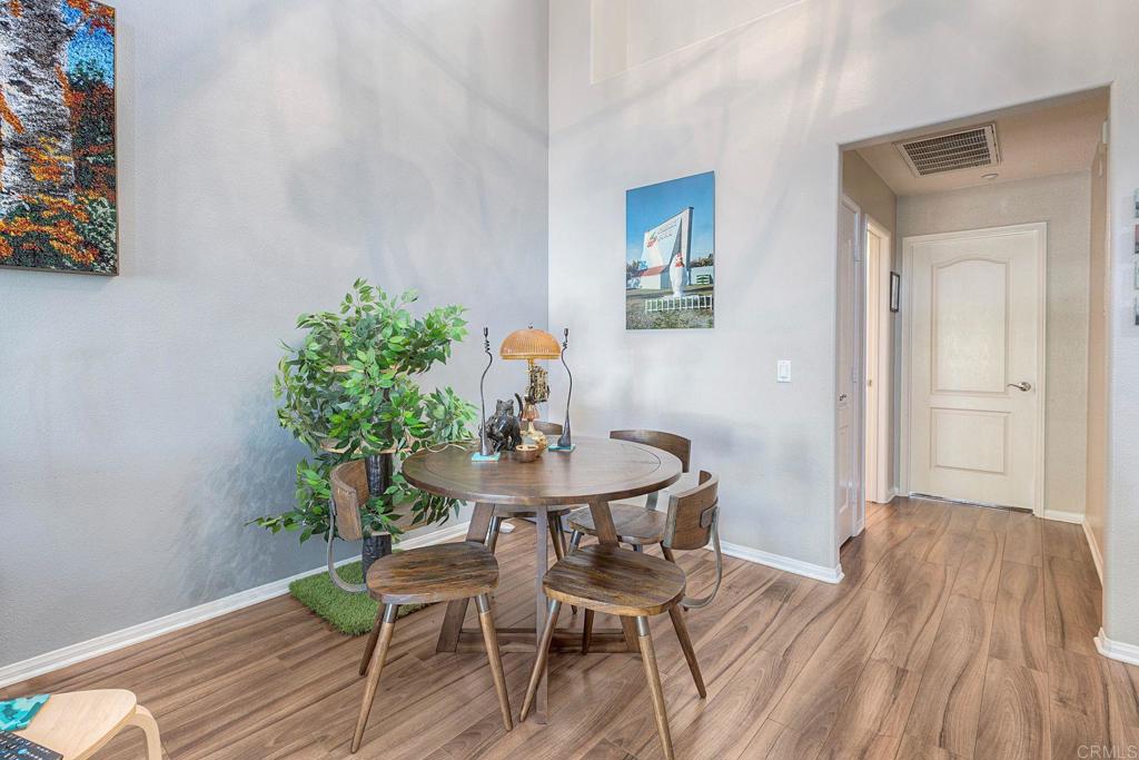 40238 Rosewell Court Temecula, CA 92591 - Photo 9 of 38 a view of a dining room with furniture and wooden floor