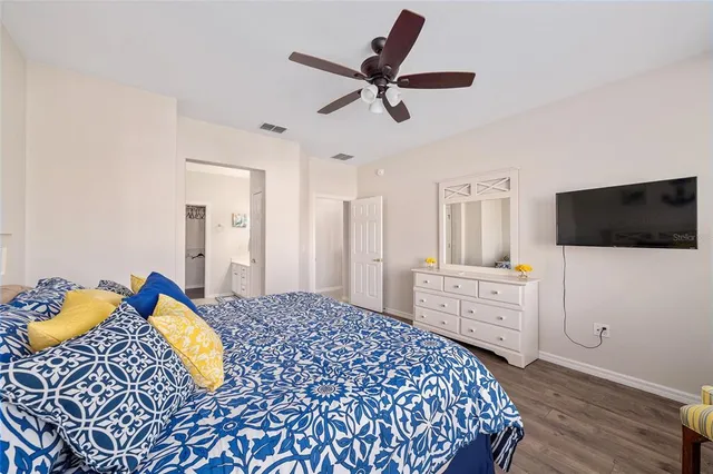a view of a hallway with wooden floor and entryway