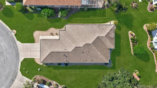 an aerial view of a city with lots of residential buildings and ocean view in back