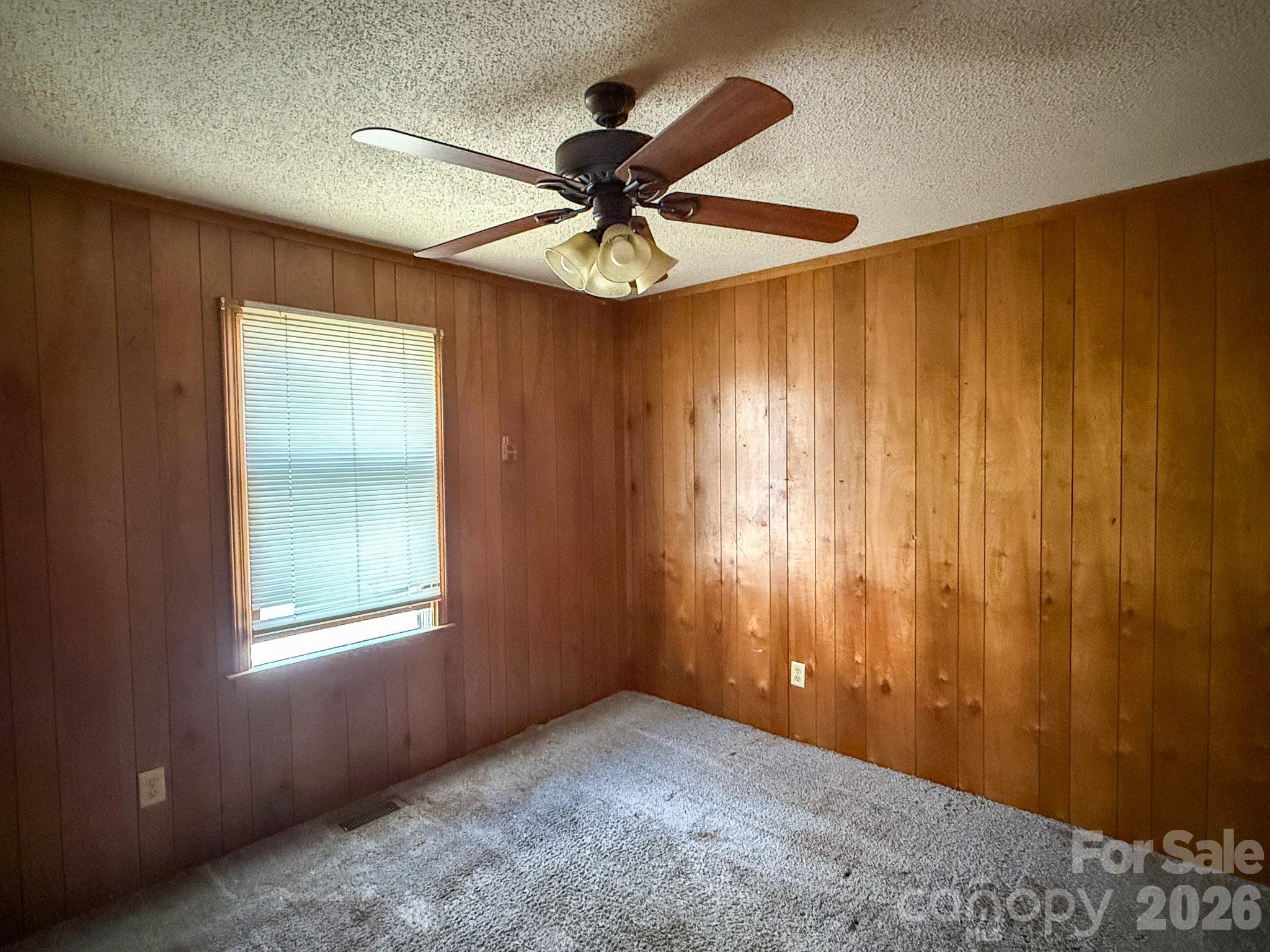 4562 Grassy Creek Road Denver, NC 28037 - Photo 15 of 24 an empty room with windows and fan